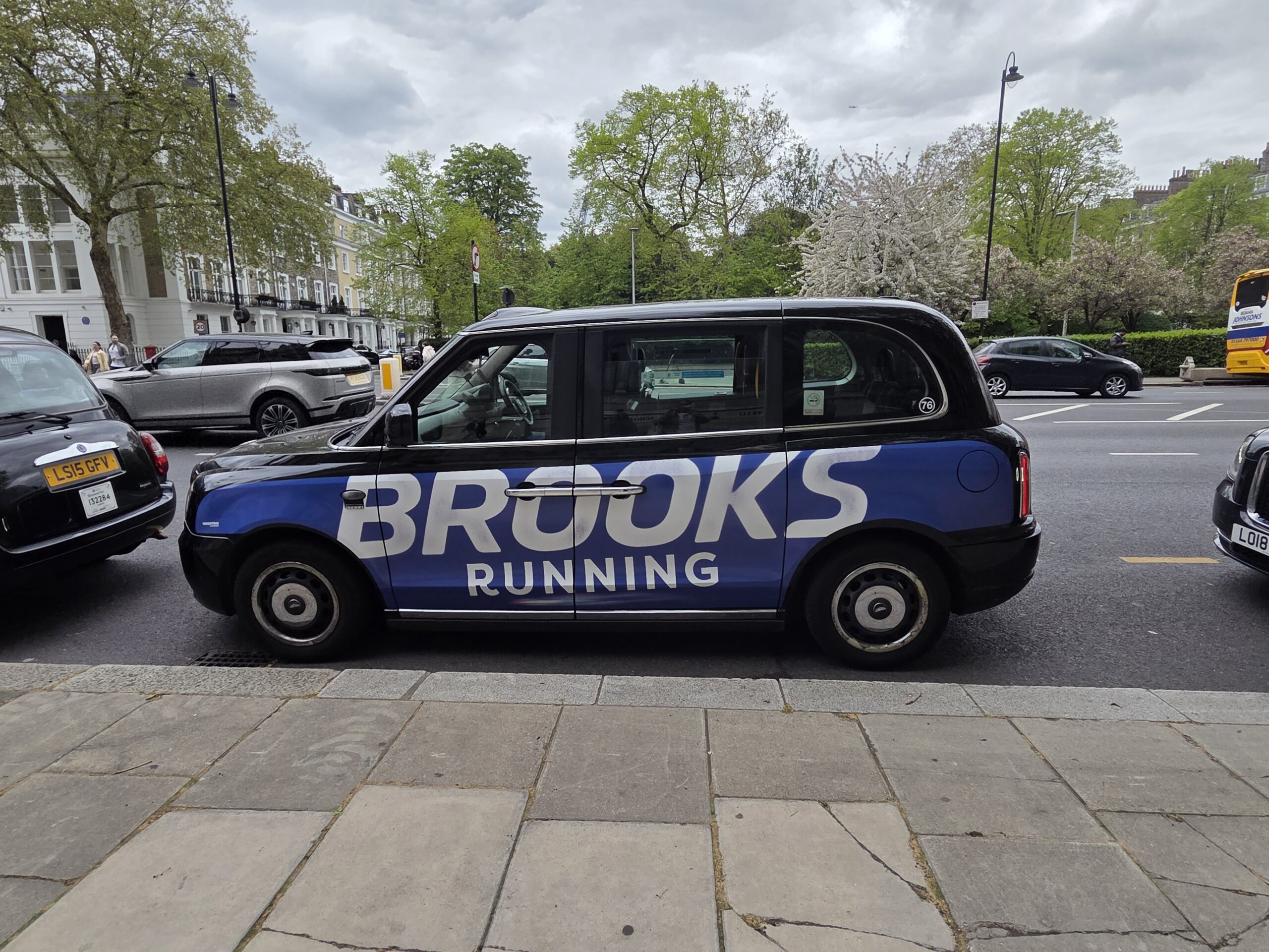 Taxi londonien arborant sur sa carrosserie une publicité pour brooks